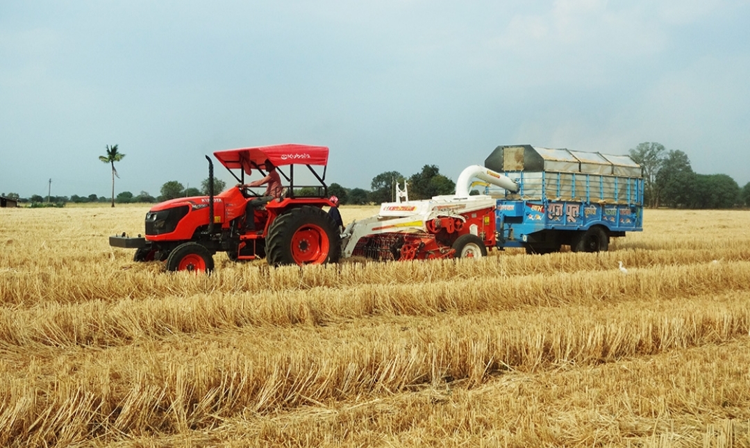 farmer using agricultural machinery india